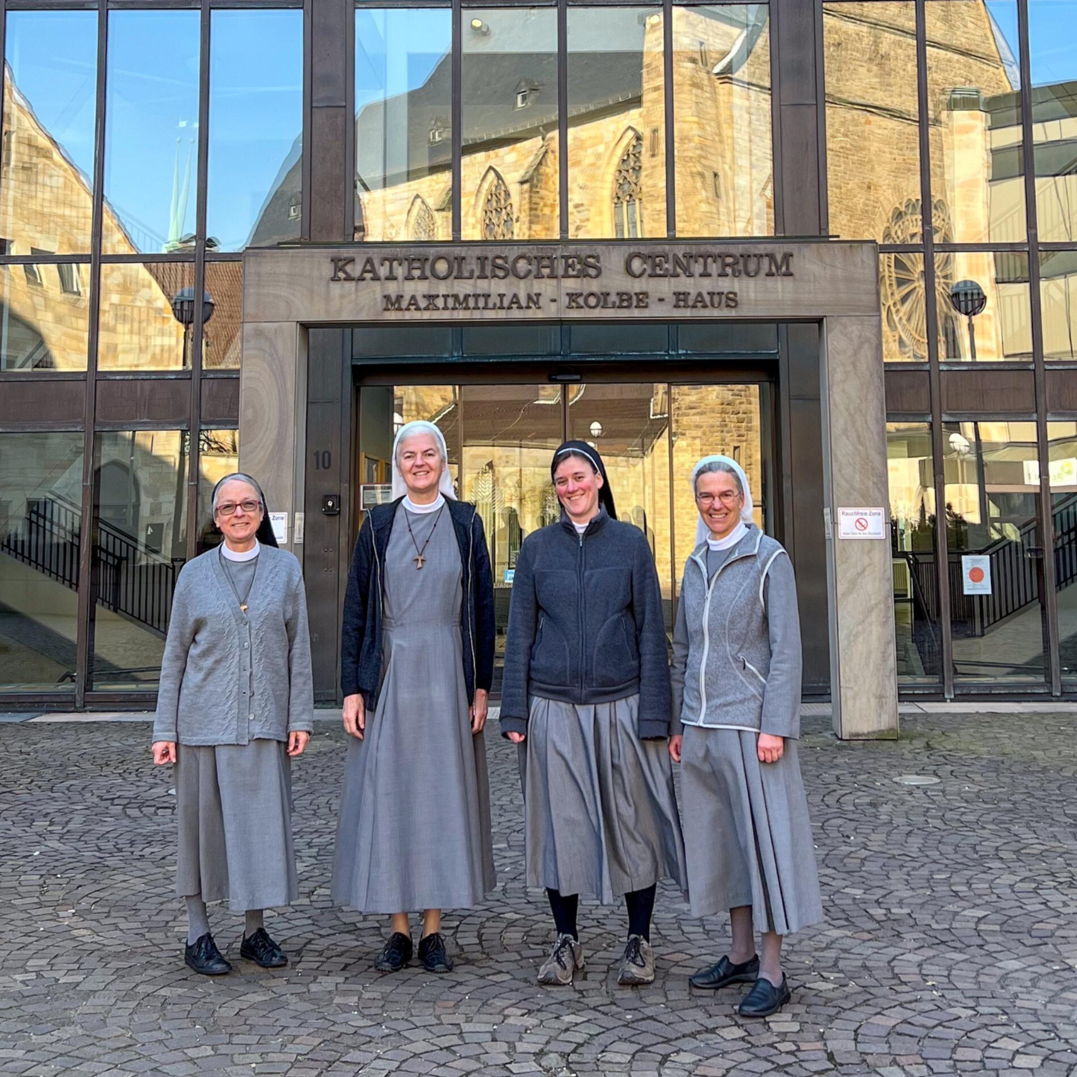 Schwester Maria, Schwester Marilen, Schwester Franja und Schwester Annette (von links) vor dem Katholischen Centrum in Dortmund. In den Fenstern spiegelt sich die Propsteikirche.