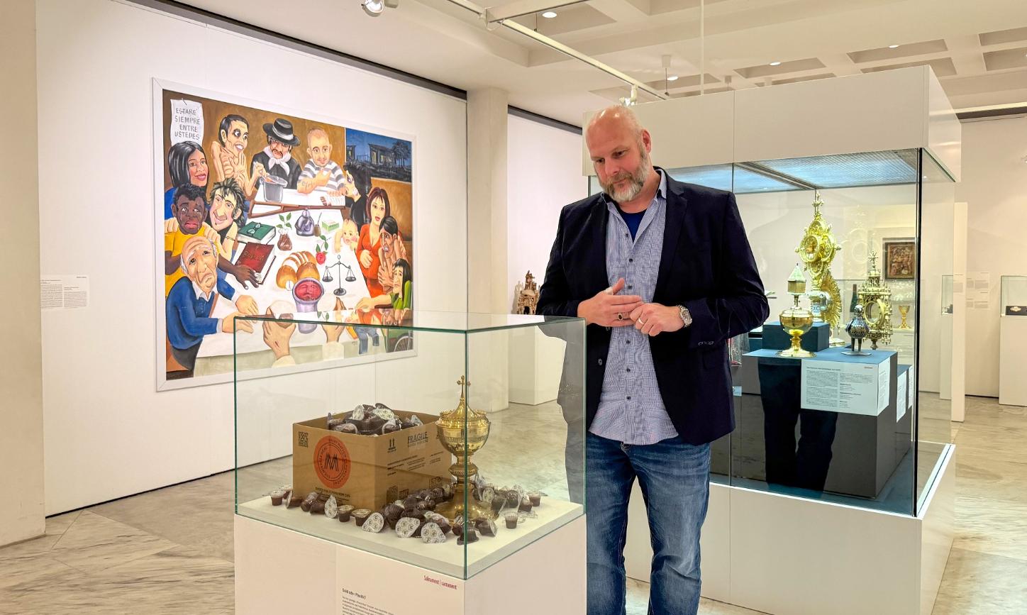 Jürgen von Ahn betrachtet das Exponat „Gold oder Plastik?“ in der Ausstellung „Das letzte Abendmahl“.