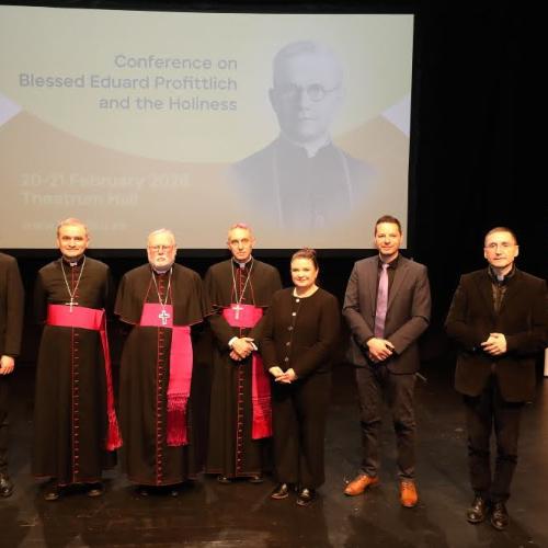Gruppenbild mit Dr. Thorsten Hoffmann (zweiter von rechts) vor Projektion und Plakat von Bischof Profittlich.