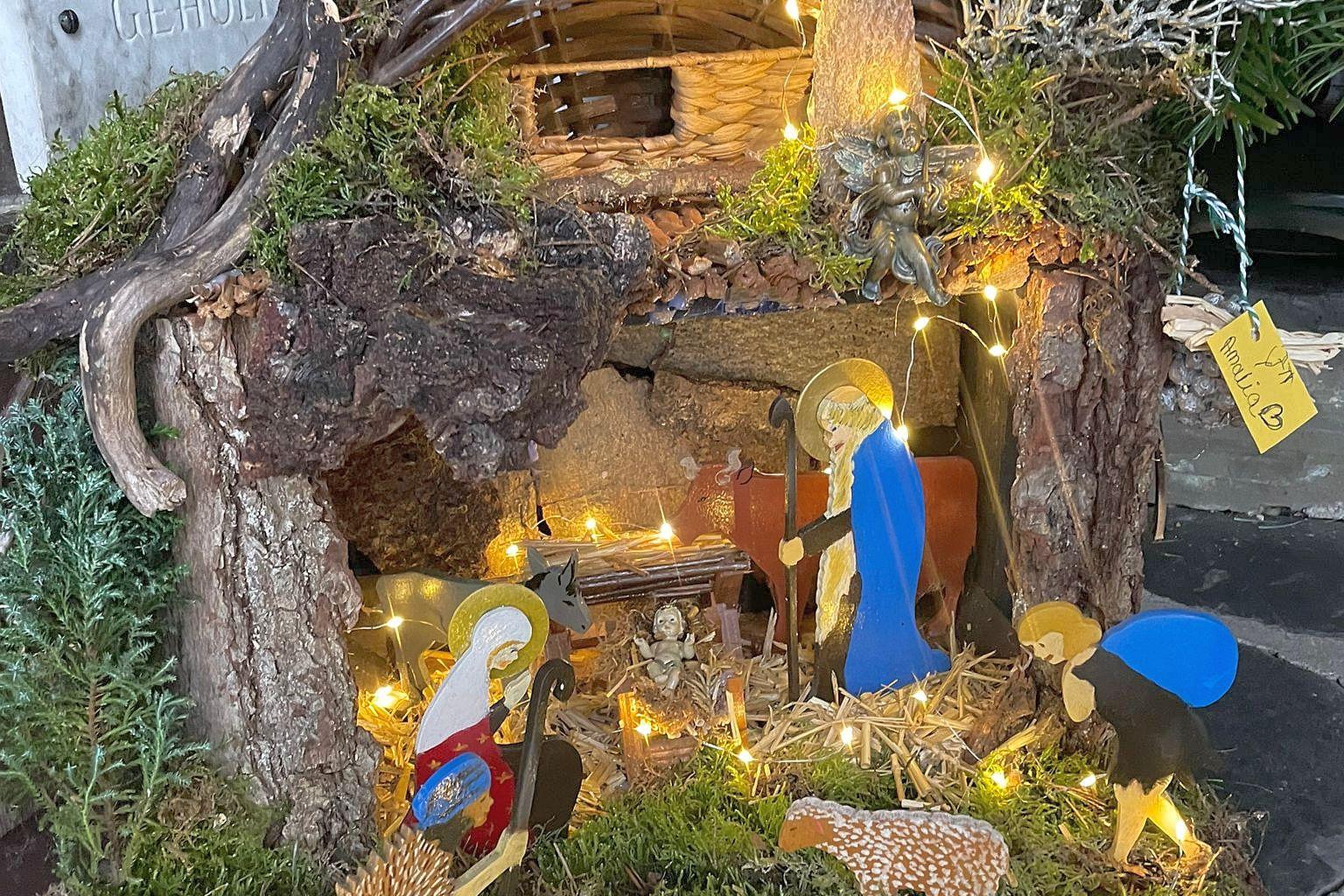 Mit kleinen Lichtern beleuchtete Weihnachtskrippe