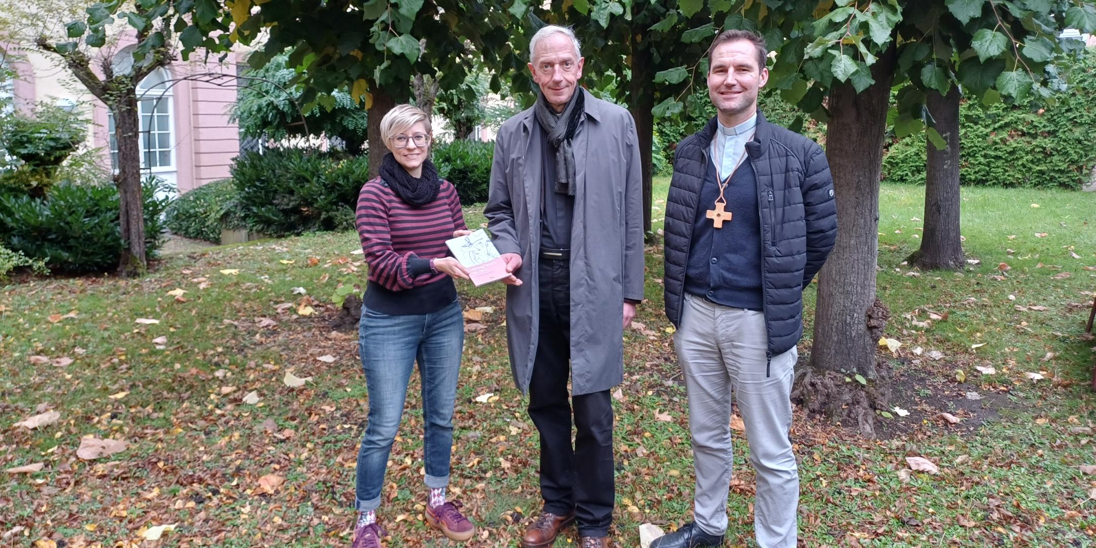 Julia Lehn und Peter Zillgen (rechts) übergeben ein Exemplar des Zeitzeugen-Bandes an Domkapitular und Interviewpartner Benedikt Welter. (c) privat Julia Lehn und Peter Zillgen (rechts) übergeben ein Exemplar des Zeitzeugen-Bandes an Domkapitular und Interviewpartner Benedikt Welter.